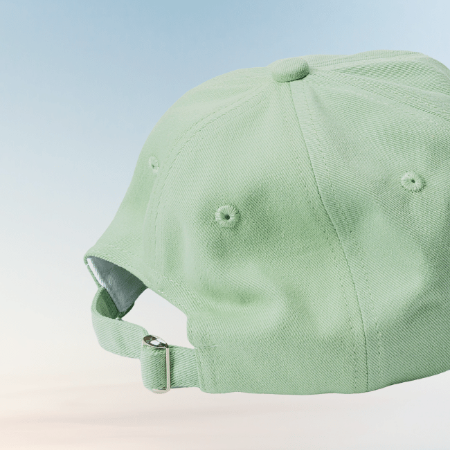 Back view of the matcha-green Energise Focus Glow cap, showing its adjustable fabric strap, metal buckle and stitched ventilation eyelets.