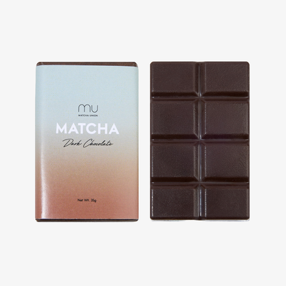 Matcha Union 35g vegan dark chocolate bar made with Japanese matcha, shown unwrapped beside its pastel packaging.