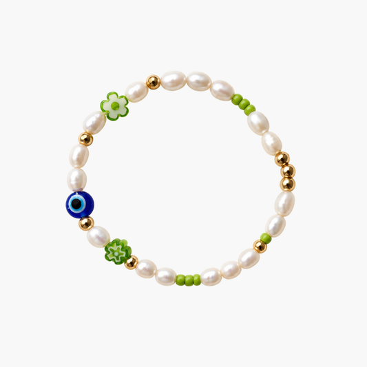 Matcha Union x Oh Luna bracelet with freshwater pearls, gold stainless steel beads, green glass flower beads and a blue eye bead on a white background.