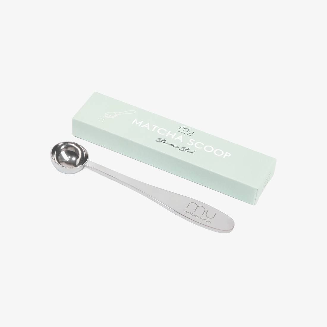 Stainless steel Perfect Matcha Scoop with an engraved Matcha Union logo beside its mint-green box, sized to measure one serving of matcha.