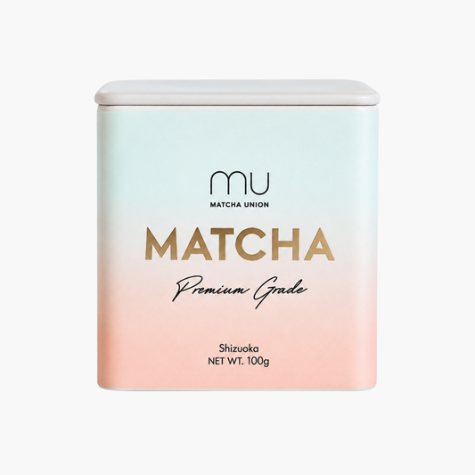 Matcha Union Premium Matcha 100g tin with a mint-to-peach gradient label, containing Japanese green tea powder from Shizuoka for everyday matcha lattes.